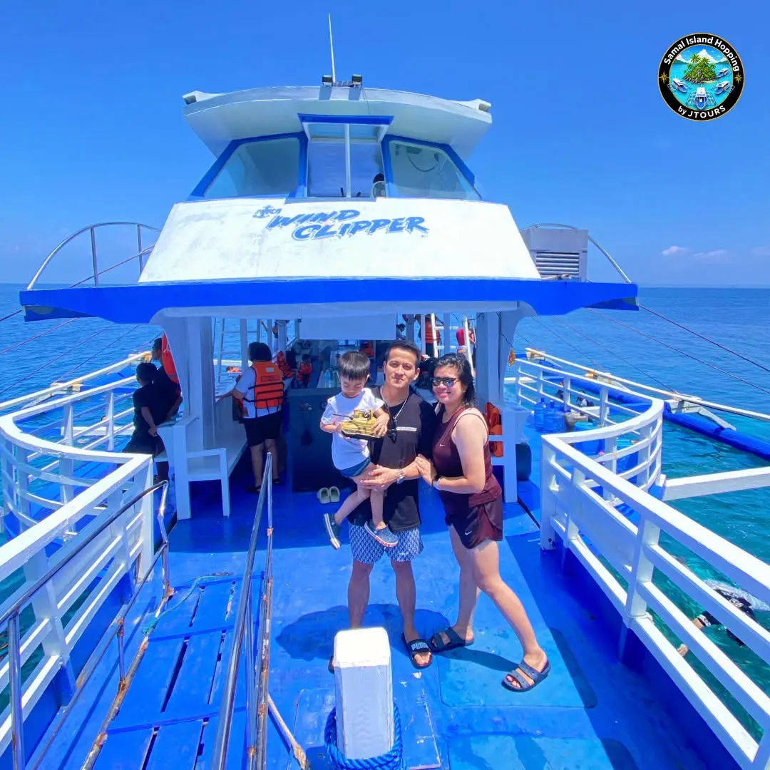 Family on the blue deck of the Wind Clipper boat